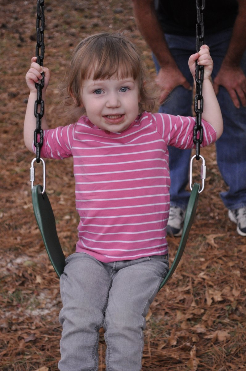 Harper swinging at Grandpa Jim's